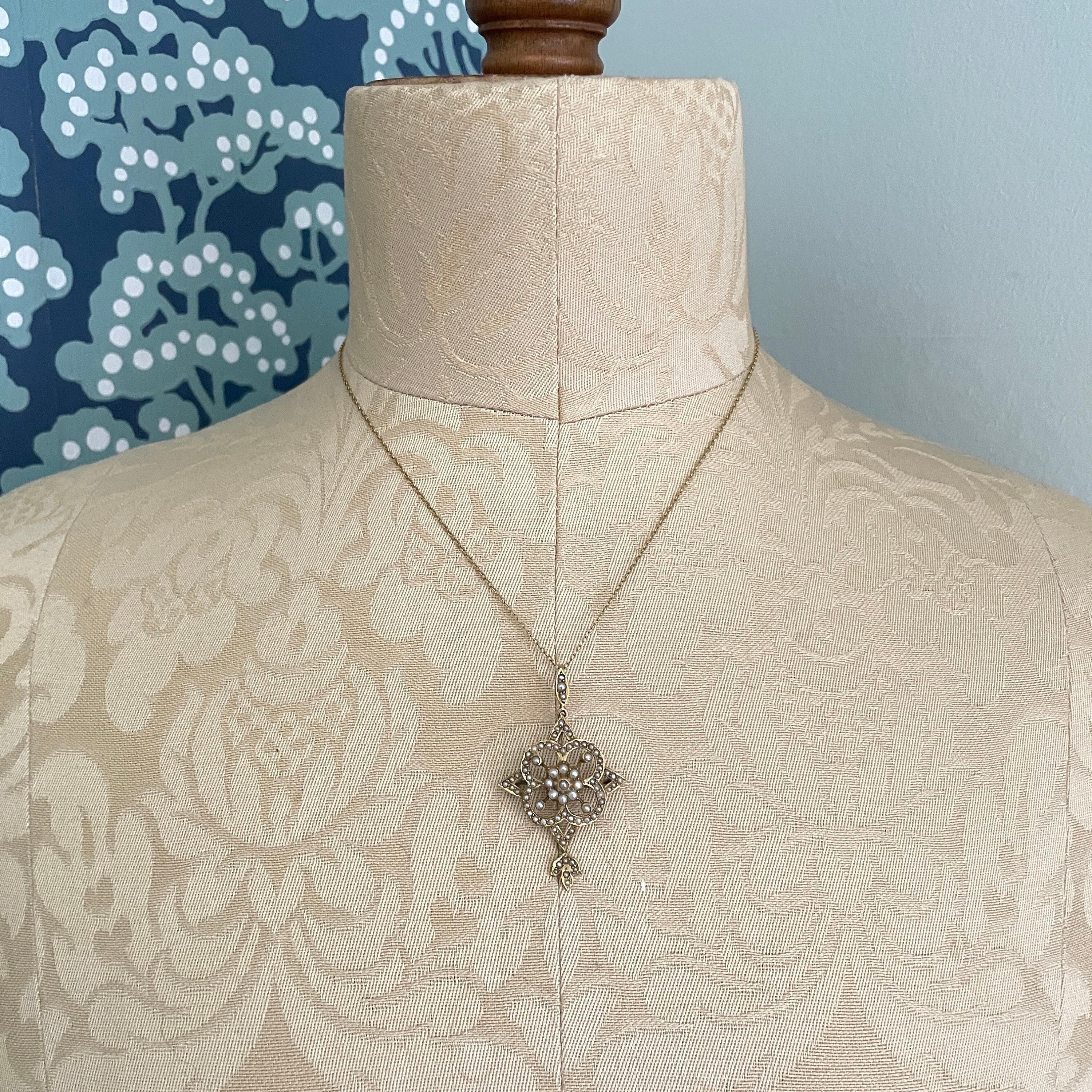 Edwardian 9ct gold filigree pendant with seed pearls on fine gold chain, floral quatrefoil design