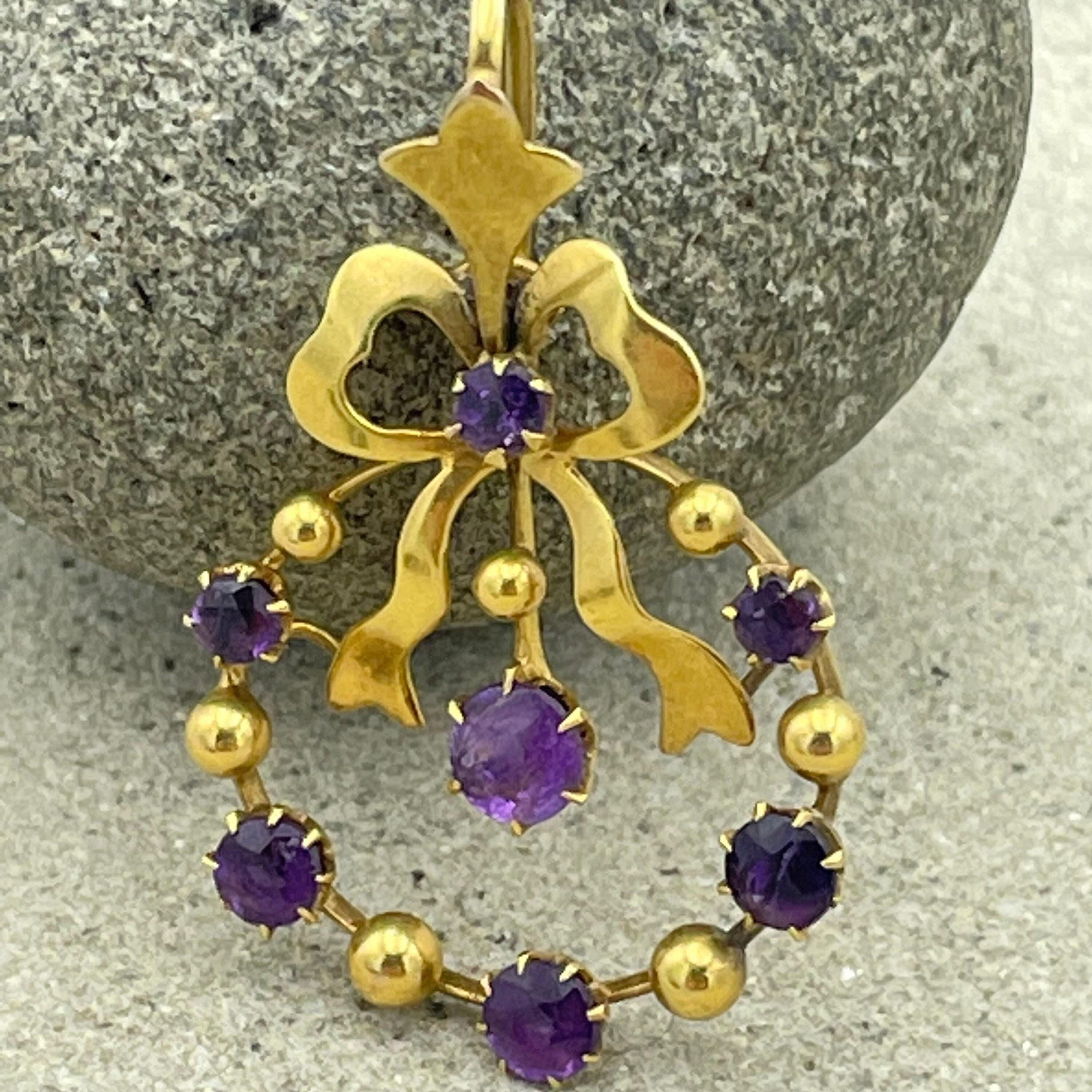 Victorian 15ct gold bow pendant with amethyst stones forming a beaded wreath